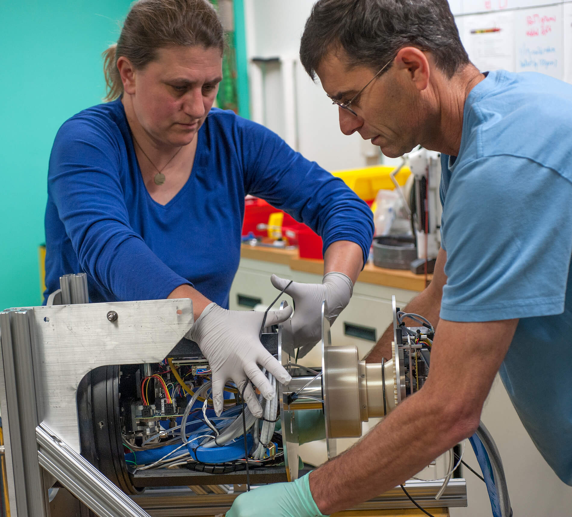 two people helping to put equipment together